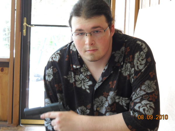 Thats part of my new porch, the shirt I'm wearing in both of my pictures is my favorite shirt and since I was taking pictures that day I thought I'd dress nice. That is a 1911 though I've been told many times that it looks like a Glock from this angle, I guess because it looks squared but trust me its a 1911 in .38 special. This is my favorite 1911 and I think it makes me look pretty cool in this picture.