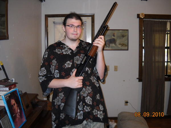 That is me holding my 20 gauge shotgun, its a Winchester model 1200 speed pump. I use it for contests and home defense along with trap and skeet shooting and of course hunting. The stock is a Knoxx kick reducer, which reduces the kick of it by something like 62% which is a whole lot especially when a follow up shot is required. Yes the pump is still the original wood but when I received this shotgun I was 13 and so it had a child stock which didn't fit when I grew to be 6'2'' lol. So I ordered the replacement system from blackhawk tactical and the pump doesn't fit, I think its because it was made for the 12 gauge more than the 20 but I will get around one of these days to doing something about it I just think it looks awesome